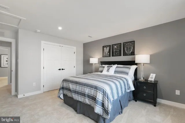 a bedroom with a bed and a night stand