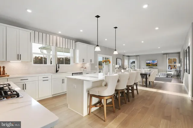 a large kitchen with a table and chairs in it