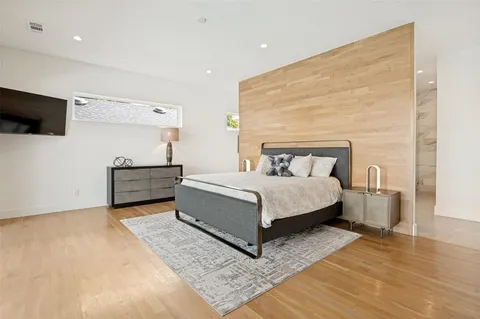 a bedroom with a bed and flat screen tv