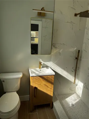 a bathroom with a sink toilet and shower