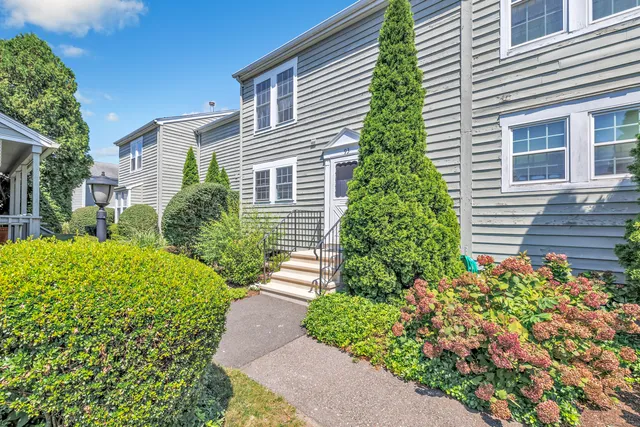 a view of a house with potted plants