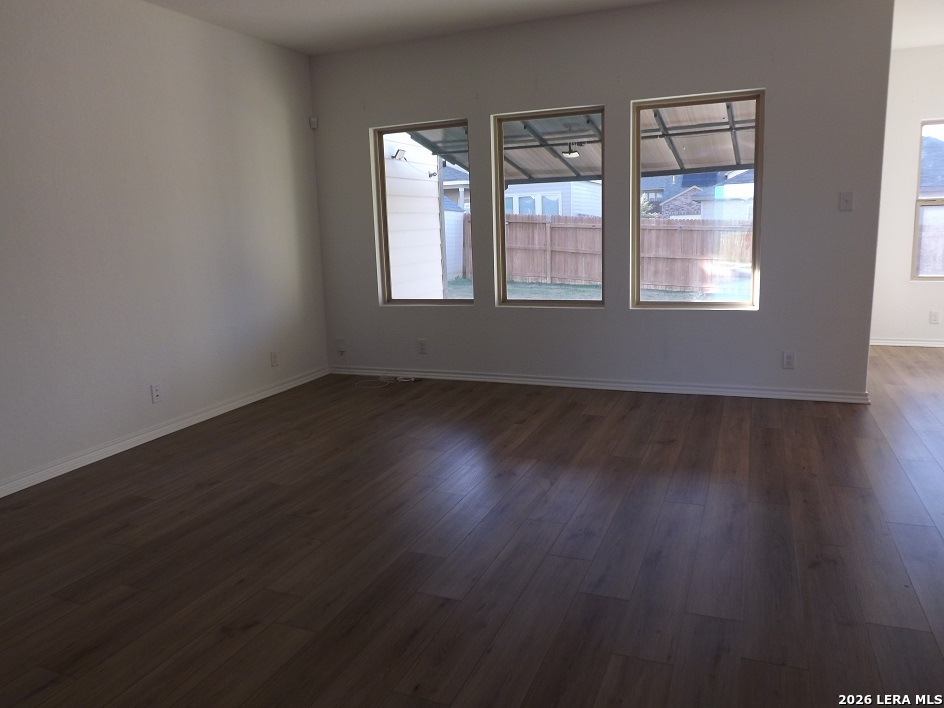 6835 Alaskan Wy. Converse, TX 78109 - Photo 22 of 22 an empty room with wooden floor and windows