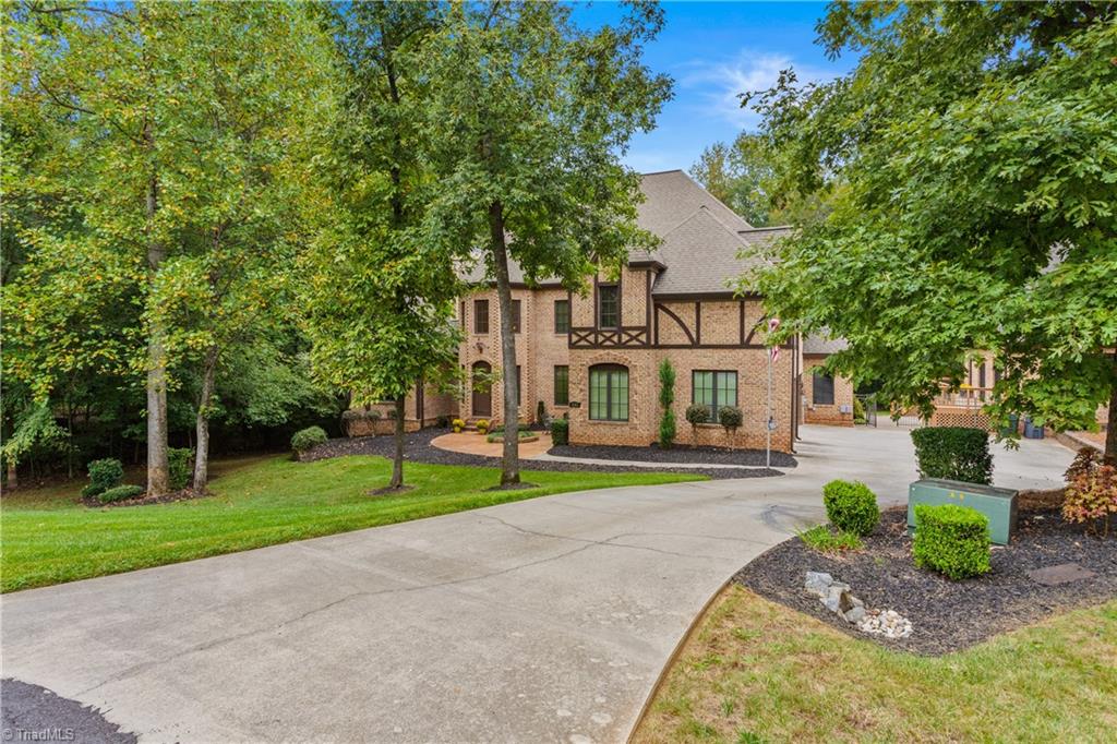 8302 Linville Oaks Drive Oak Ridge, NC 27310 - Photo 2 of 46 Back on the neighborhood in a cul-de-sac.