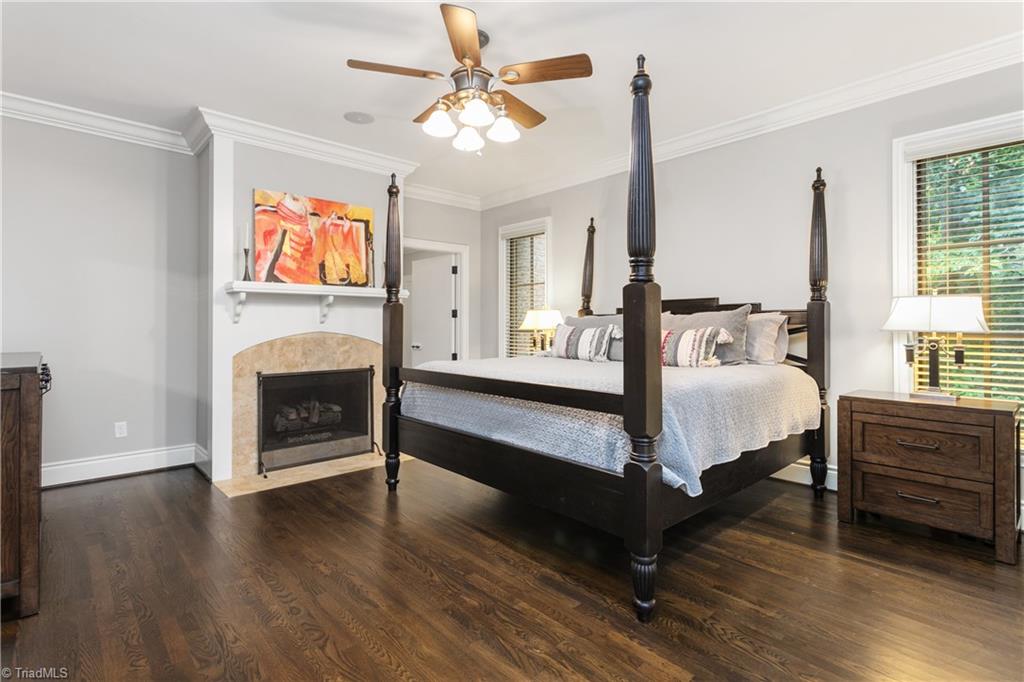 8302 Linville Oaks Drive Oak Ridge, NC 27310 - Photo 21 of 46 Primary bedroom with a private fireplace and that door leads to the study.