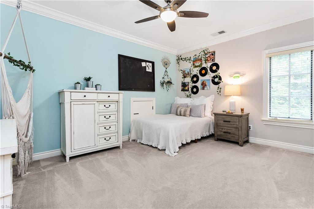 8302 Linville Oaks Drive Oak Ridge, NC 27310 - Photo 25 of 46 Large bedroom upstairs that connects to a large bathroom and has a walk-in closet.