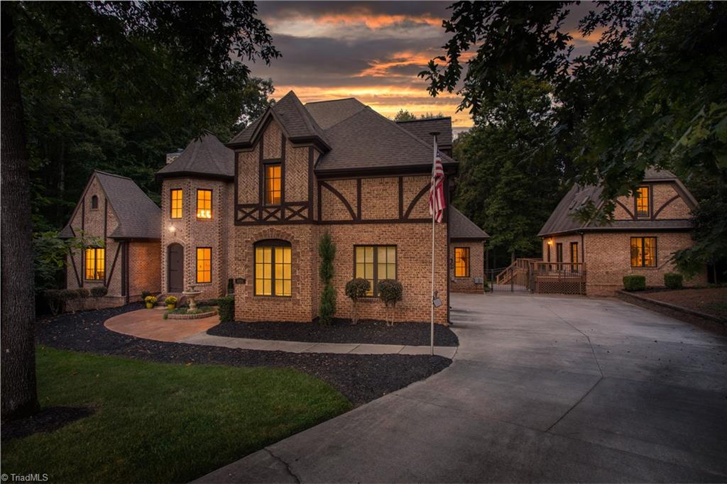8302 Linville Oaks Drive Oak Ridge, NC 27310 - Photo 4 of 46 Great view down the driveway with lots of room for parking and the pool house is such a great extra flex space.