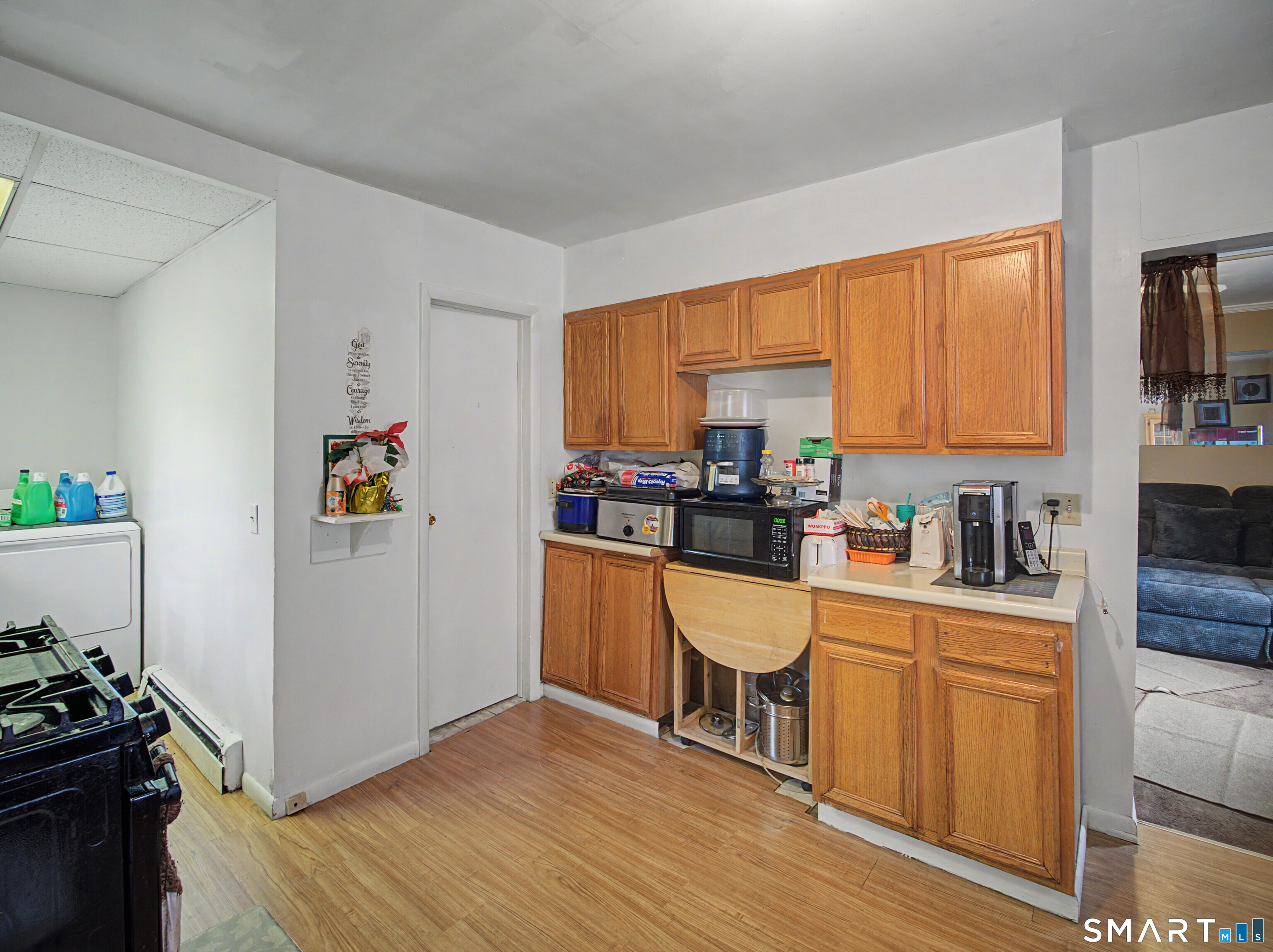 68 Rowan Street Danbury, CT 06810 - Photo 23 of 34 a kitchen with stainless steel appliances a microwave a stove a sink dishwasher and cabinets with wooden floor