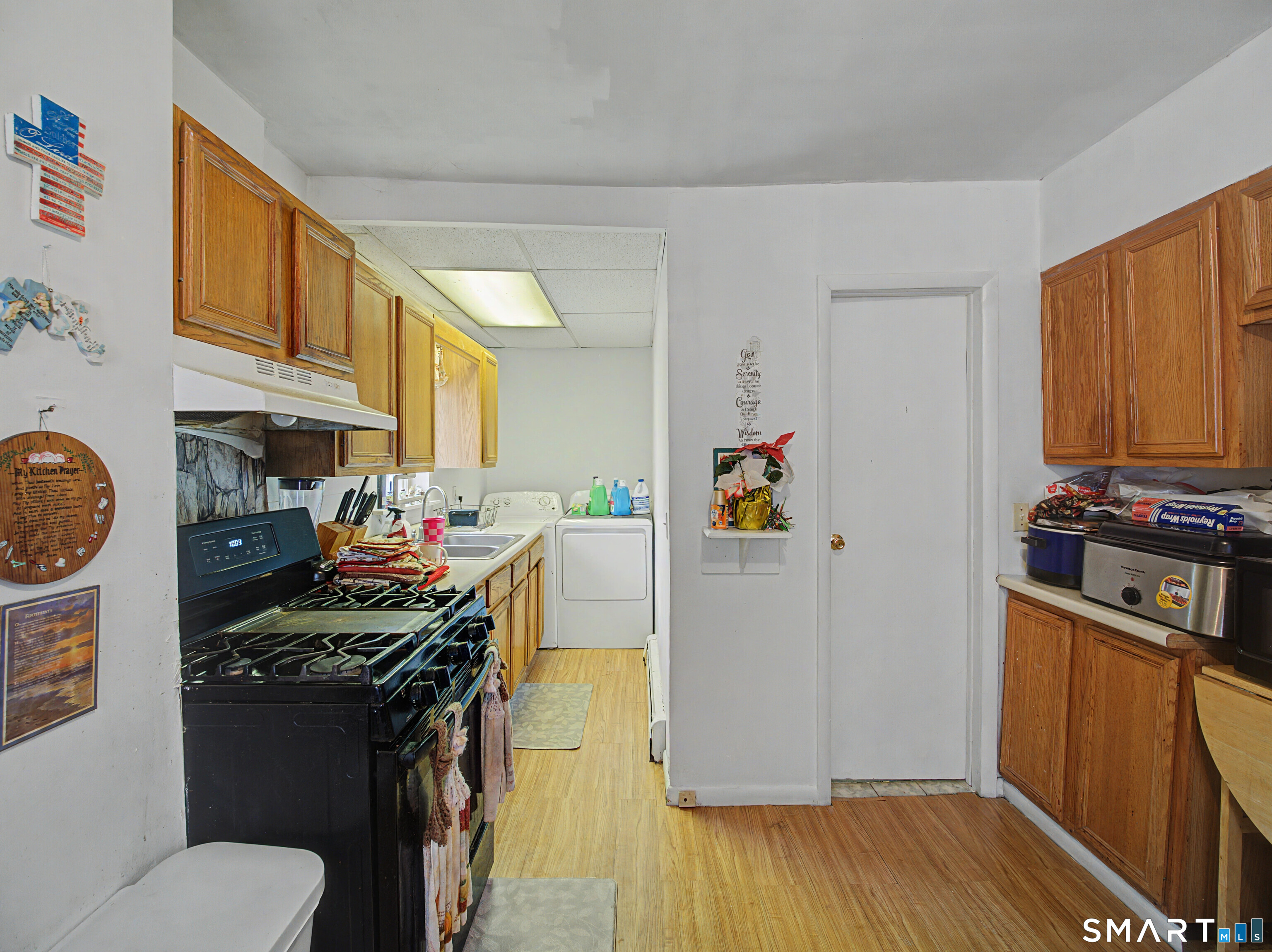 68 Rowan Street Danbury, CT 06810 - Photo 25 of 34 a kitchen with stainless steel appliances a stove a refrigerator wooden floor and cabinets