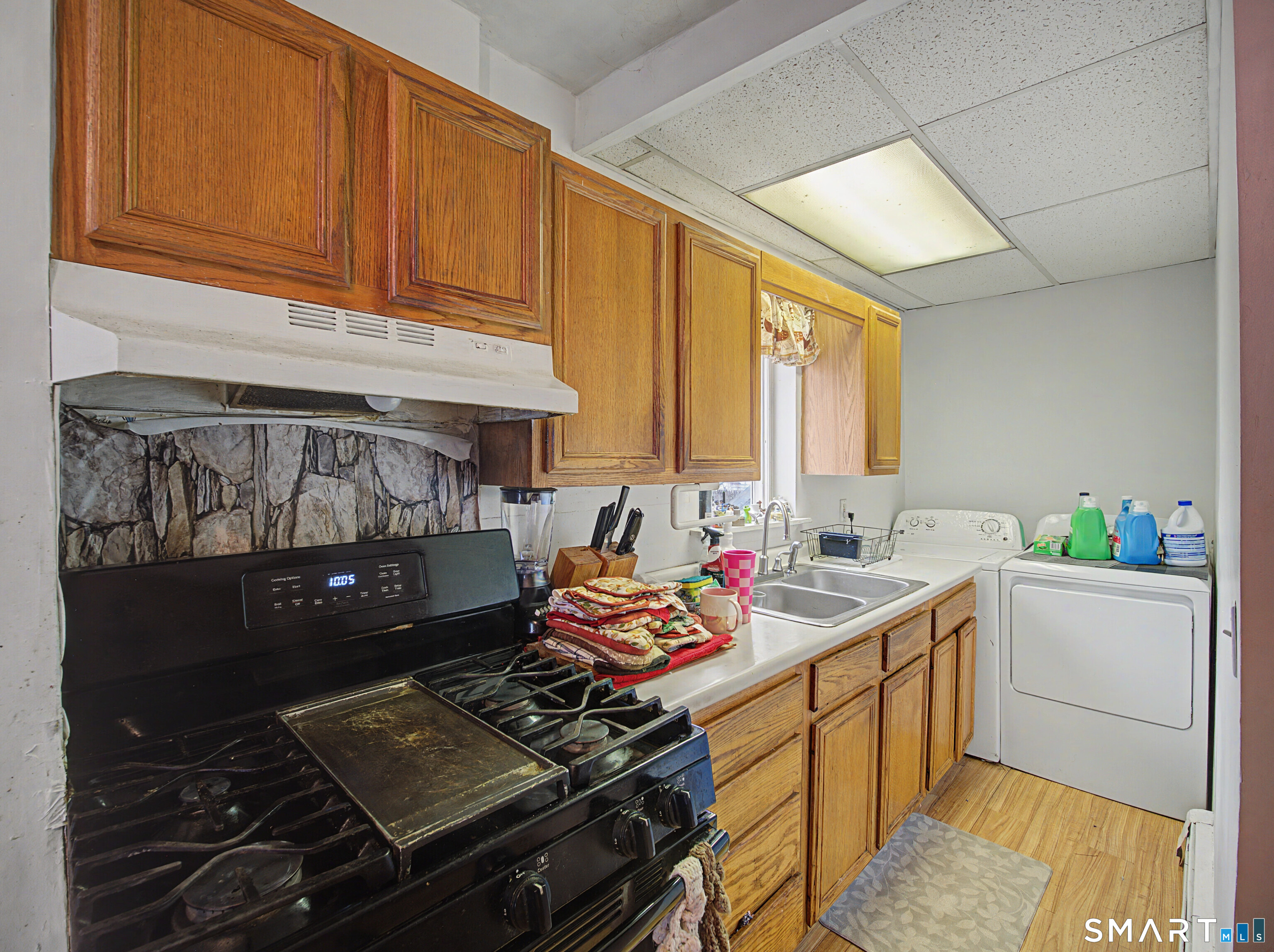 68 Rowan Street Danbury, CT 06810 - Photo 27 of 34 a kitchen with a sink stove and cabinets