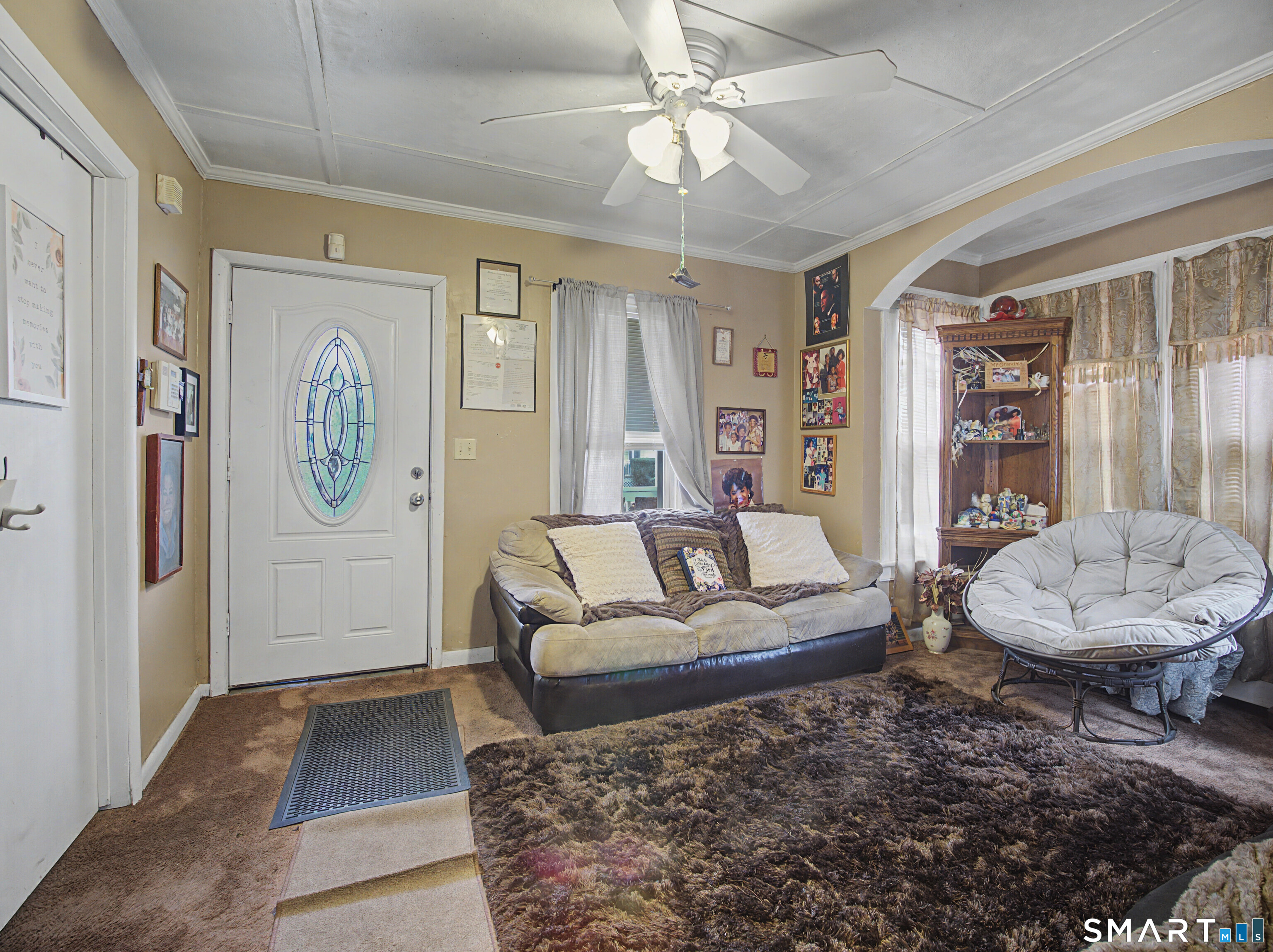 68 Rowan Street Danbury, CT 06810 - Photo 29 of 34 a living room with furniture a rug and wall paintings