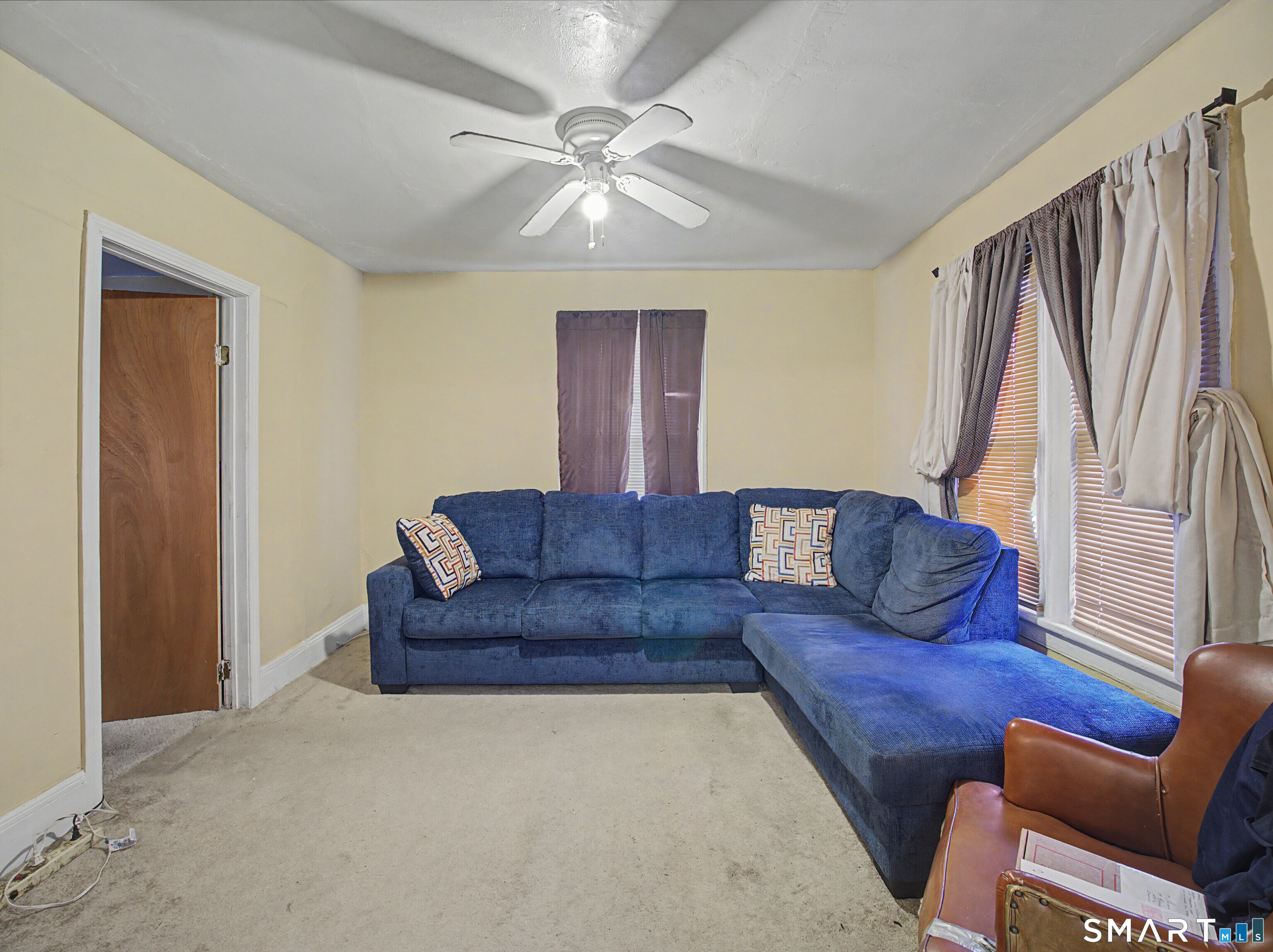 68 Rowan Street Danbury, CT 06810 - Photo 31 of 34 a living room with a couch and a chandelier