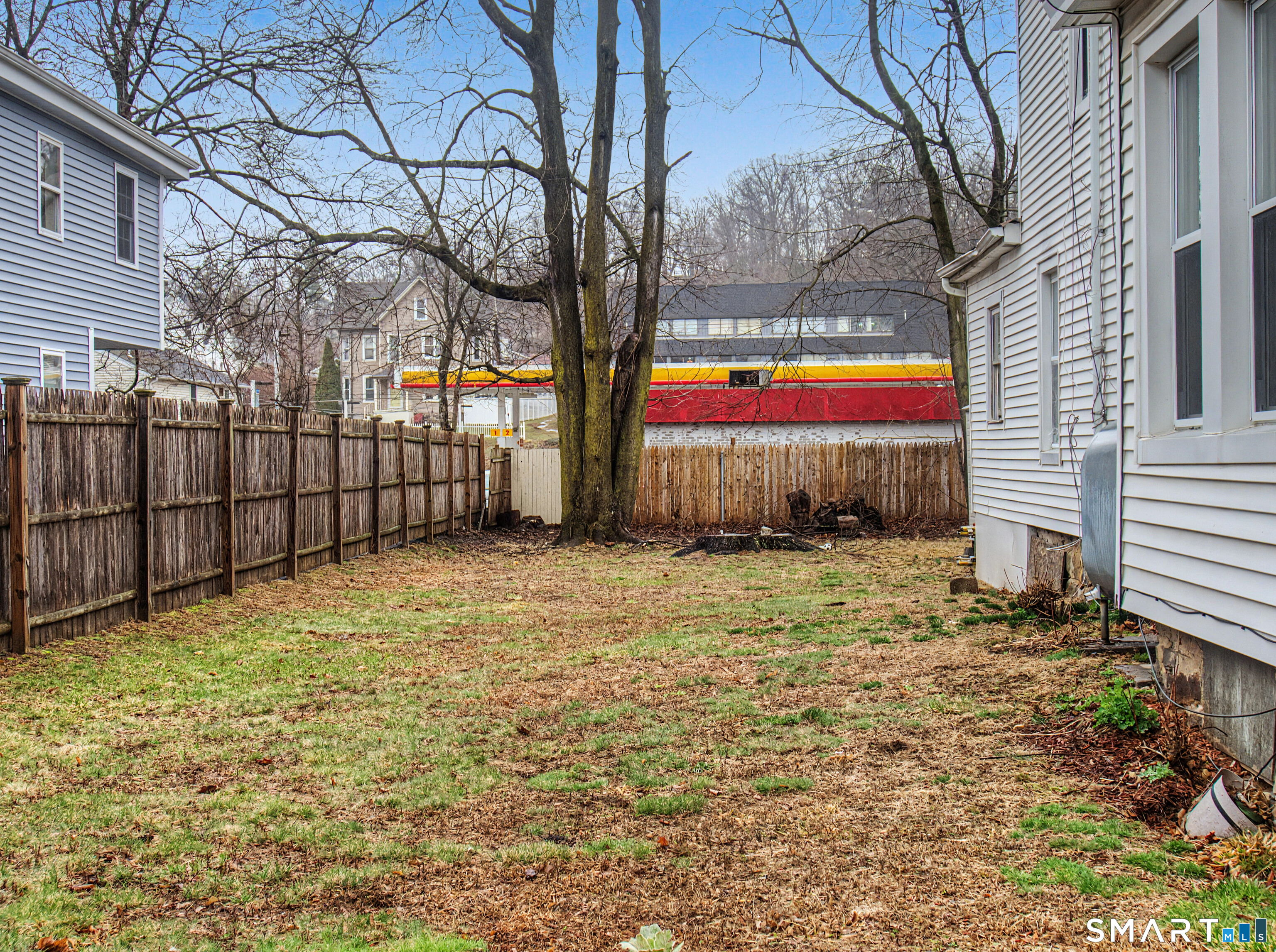 68 Rowan Street Danbury, CT 06810 - Photo 33 of 34 a backyard of a house with lots of green space