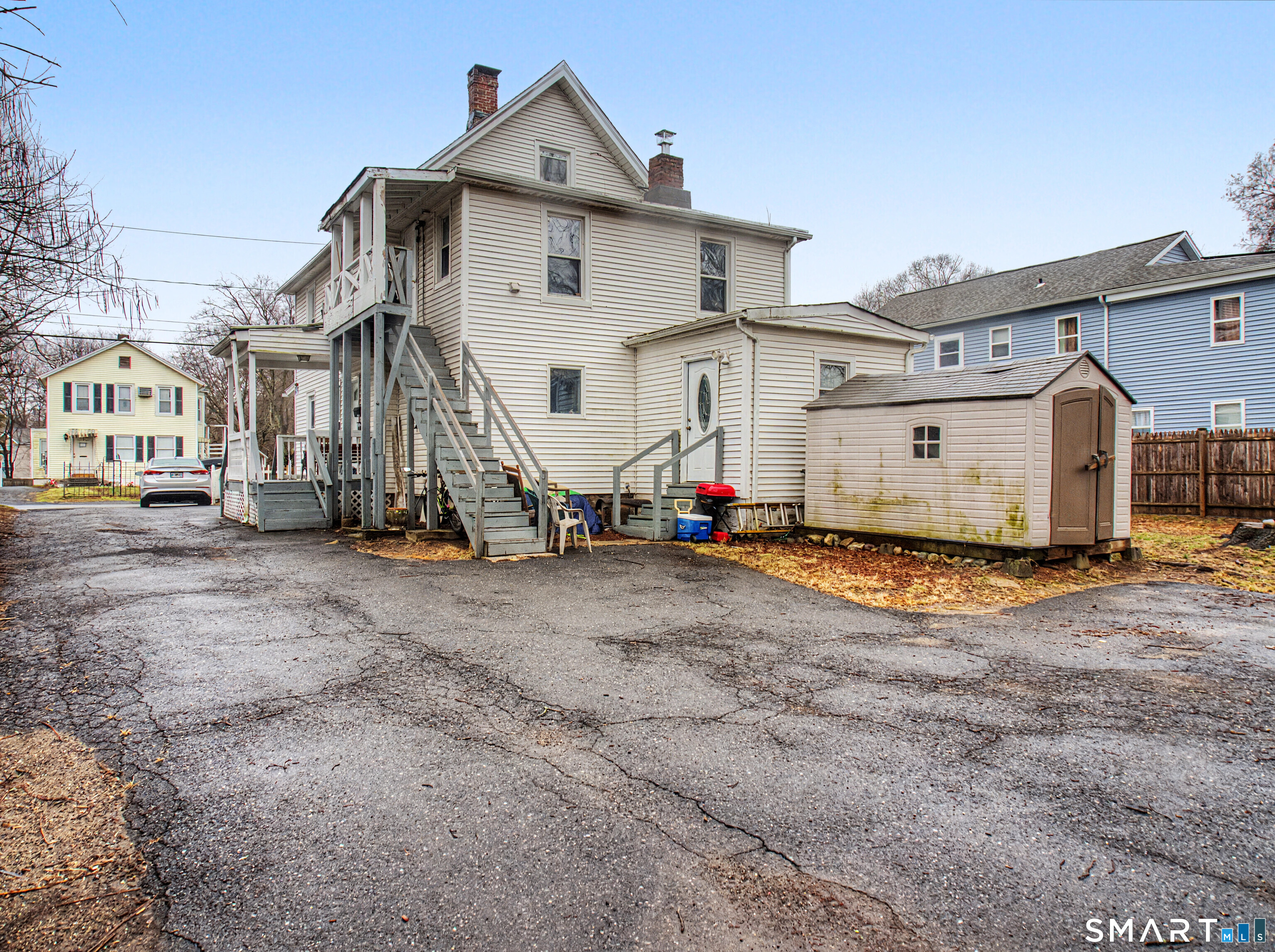 68 Rowan Street Danbury, CT 06810 - Photo 5 of 34 a view of a big house with wooden fence