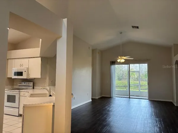 a view of a kitchen with a sink dishwasher and a fireplace