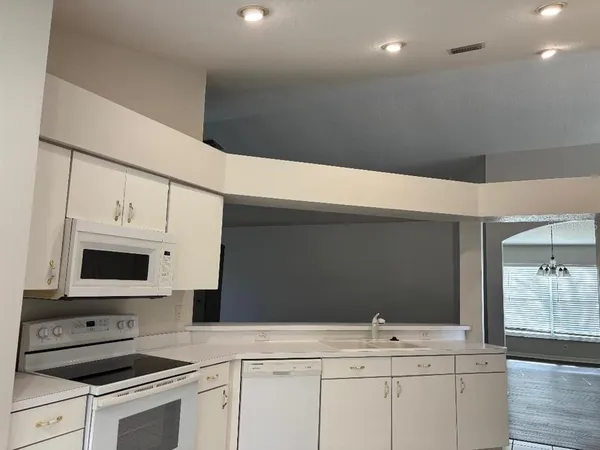 a kitchen with stainless steel appliances a sink stove and cabinets