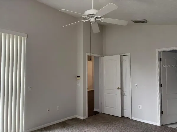 a view of a hallway with a ceiling fan