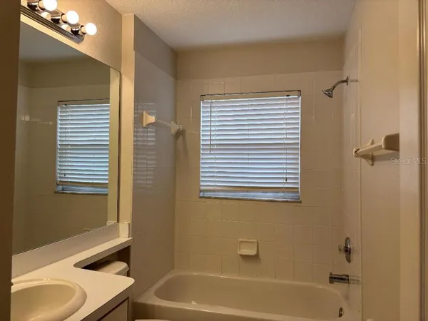 a bathroom with a tub and a sink