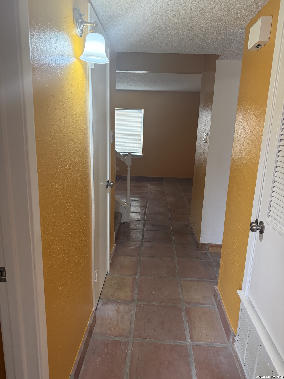 5435 Callaghan Road San Antonio, TX 78228 - Photo 12 of 38 a view of a bathroom from a corridor