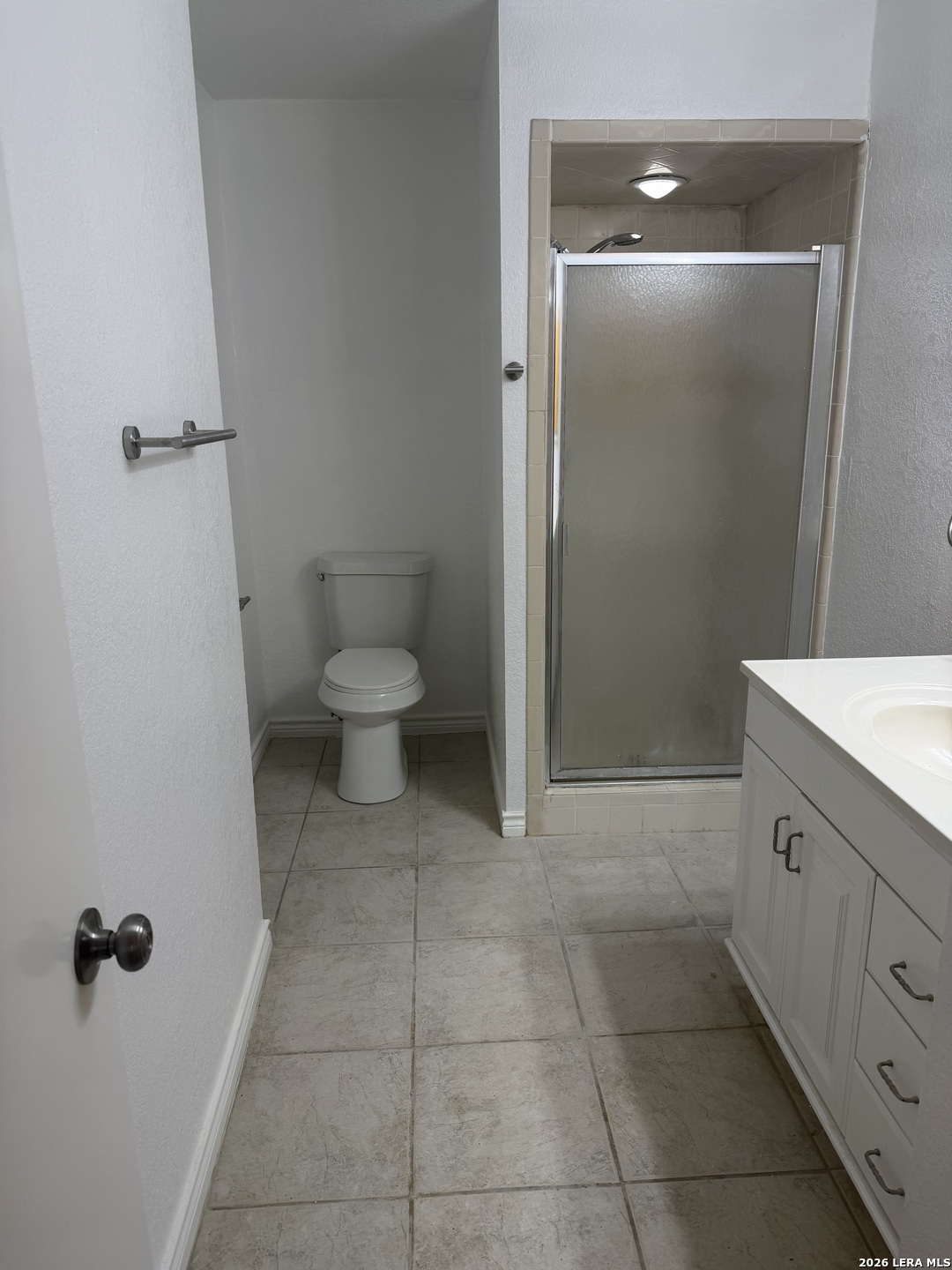 5435 Callaghan Road San Antonio, TX 78228 - Photo 18 of 38 a bathroom with a granite countertop toilet a sink and a mirror