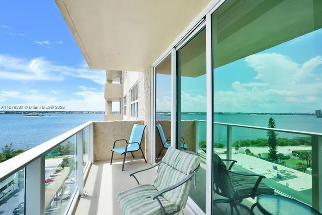 a view of balcony with a potted plant and outdoor seating