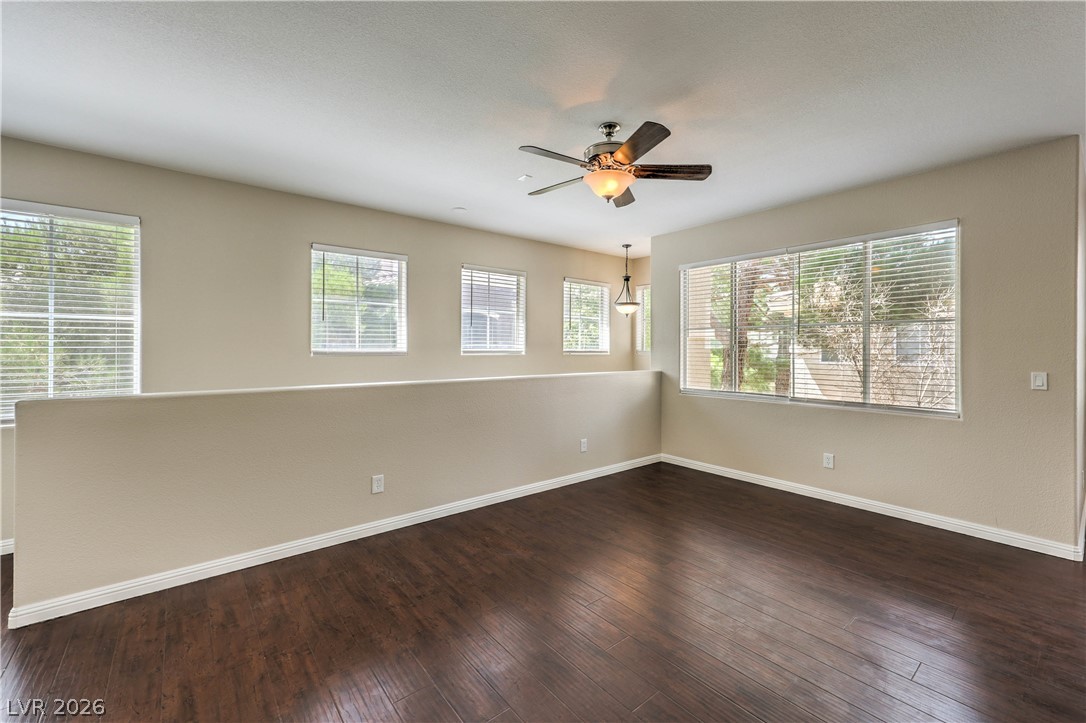9050 West Warm Springs Road, Unit 2033 Las Vegas, NV 89148 - Photo 7 of 30 Rich hardwood floors complement the natural light streaming into this versatile living space.
