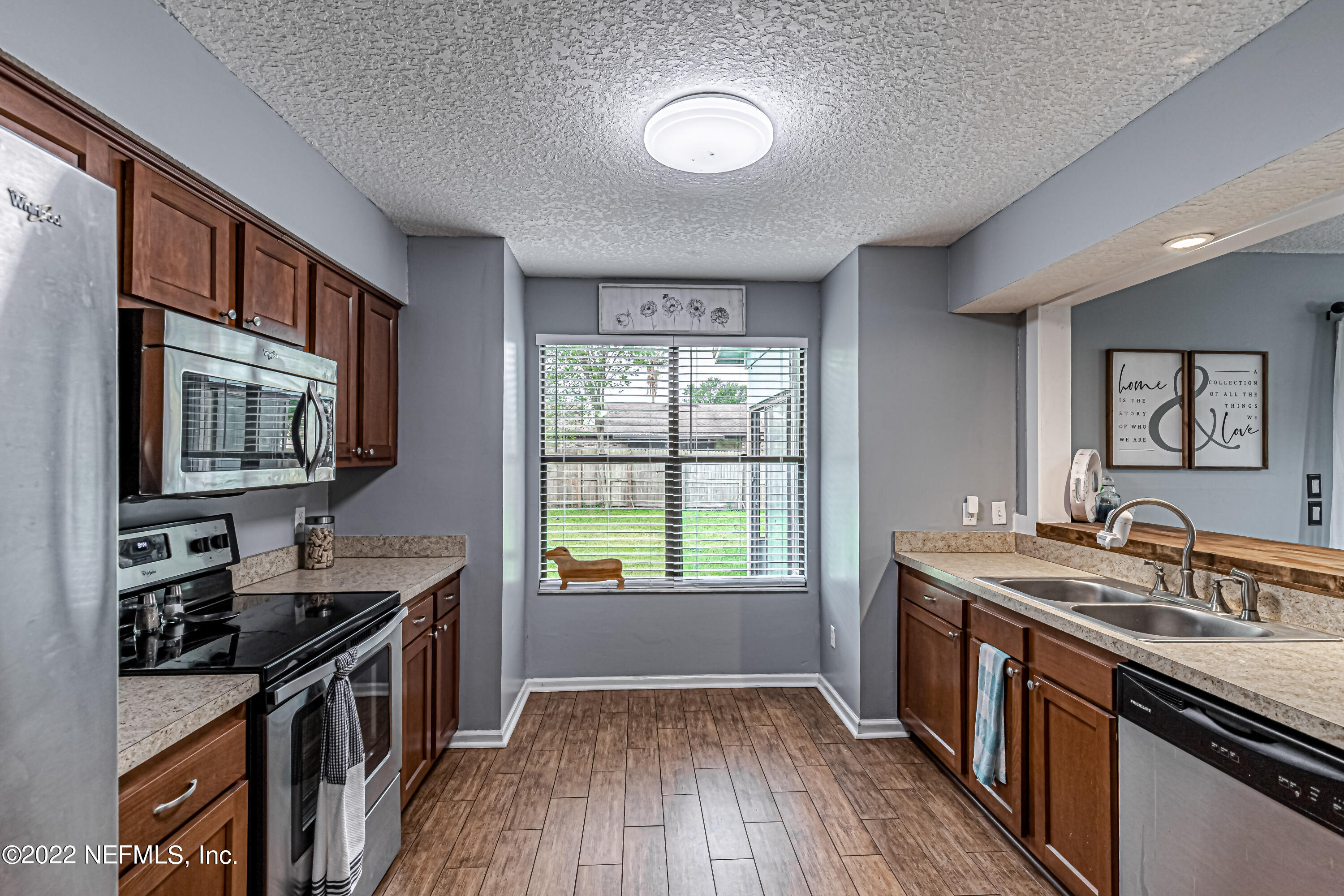 554 George Taylor Street Orange Park, FL 32073 - Photo 17 of 40 a kitchen with a stove a sink and a microwave