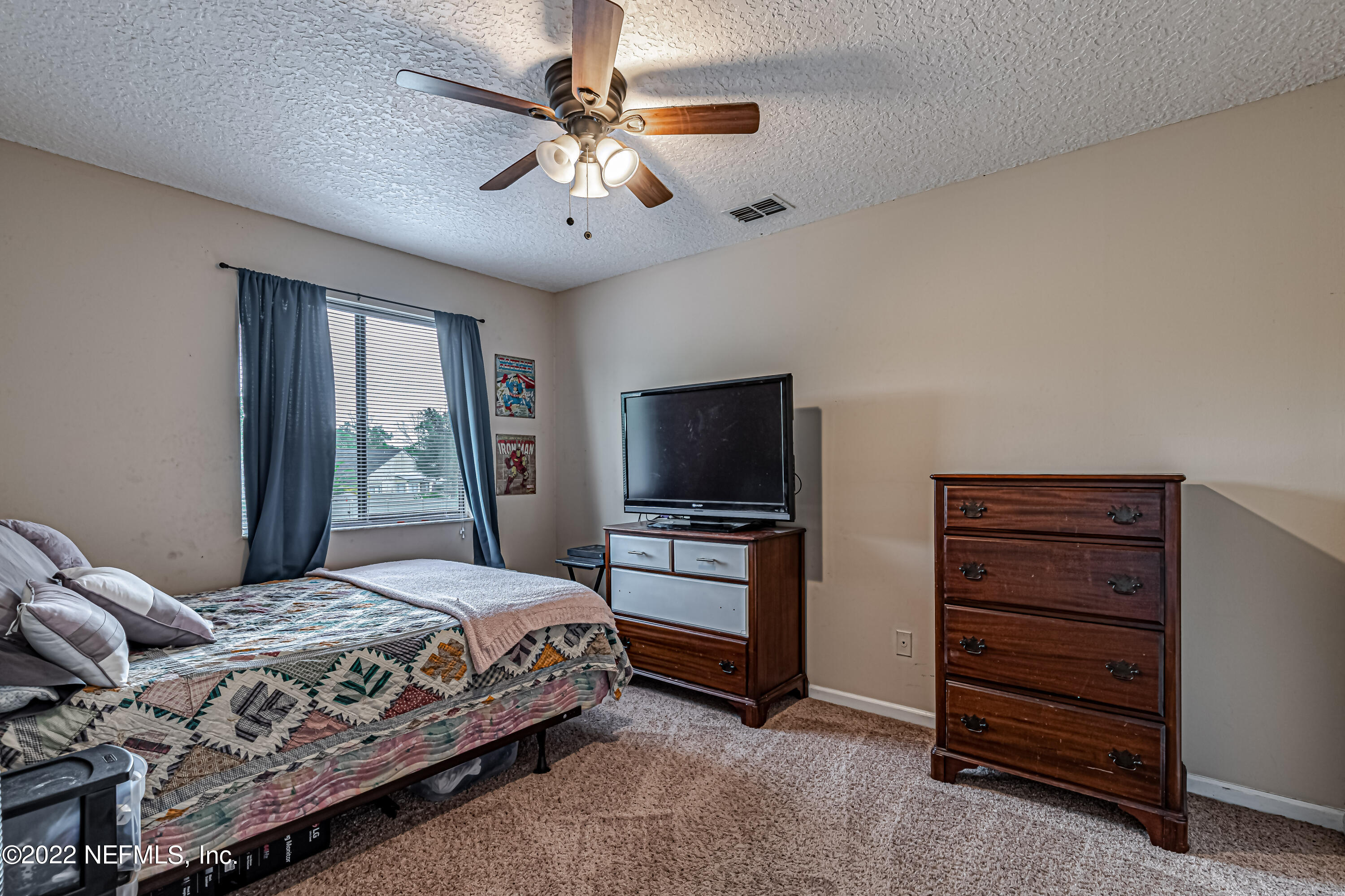 554 George Taylor Street Orange Park, FL 32073 - Photo 26 of 40 a bedroom with a large bed and flat tv