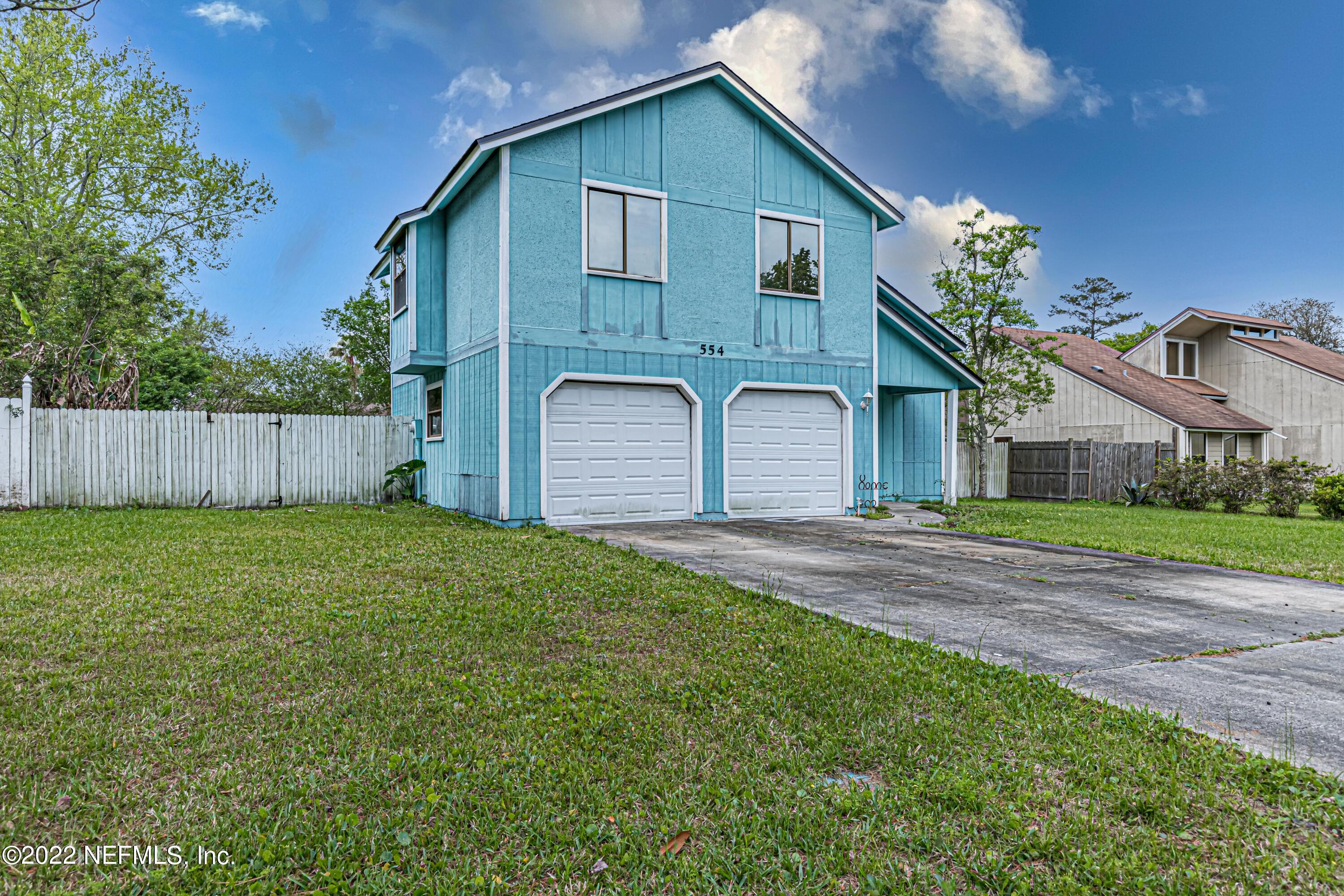 554 George Taylor Street Orange Park, FL 32073 - Photo 3 of 40 a front view of a house with a garden