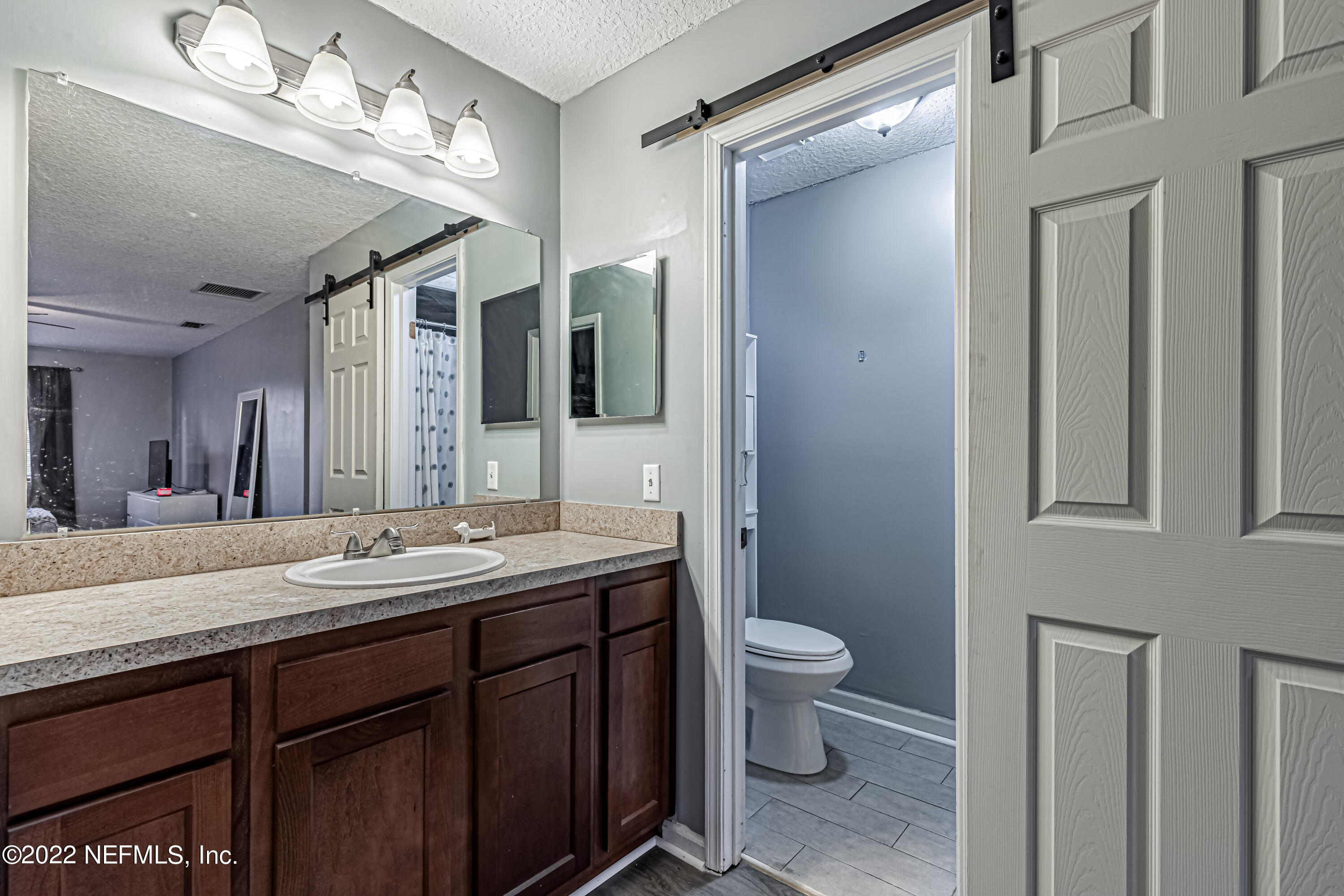 554 George Taylor Street Orange Park, FL 32073 - Photo 33 of 40 a bathroom with a granite countertop sink a toilet and a mirror