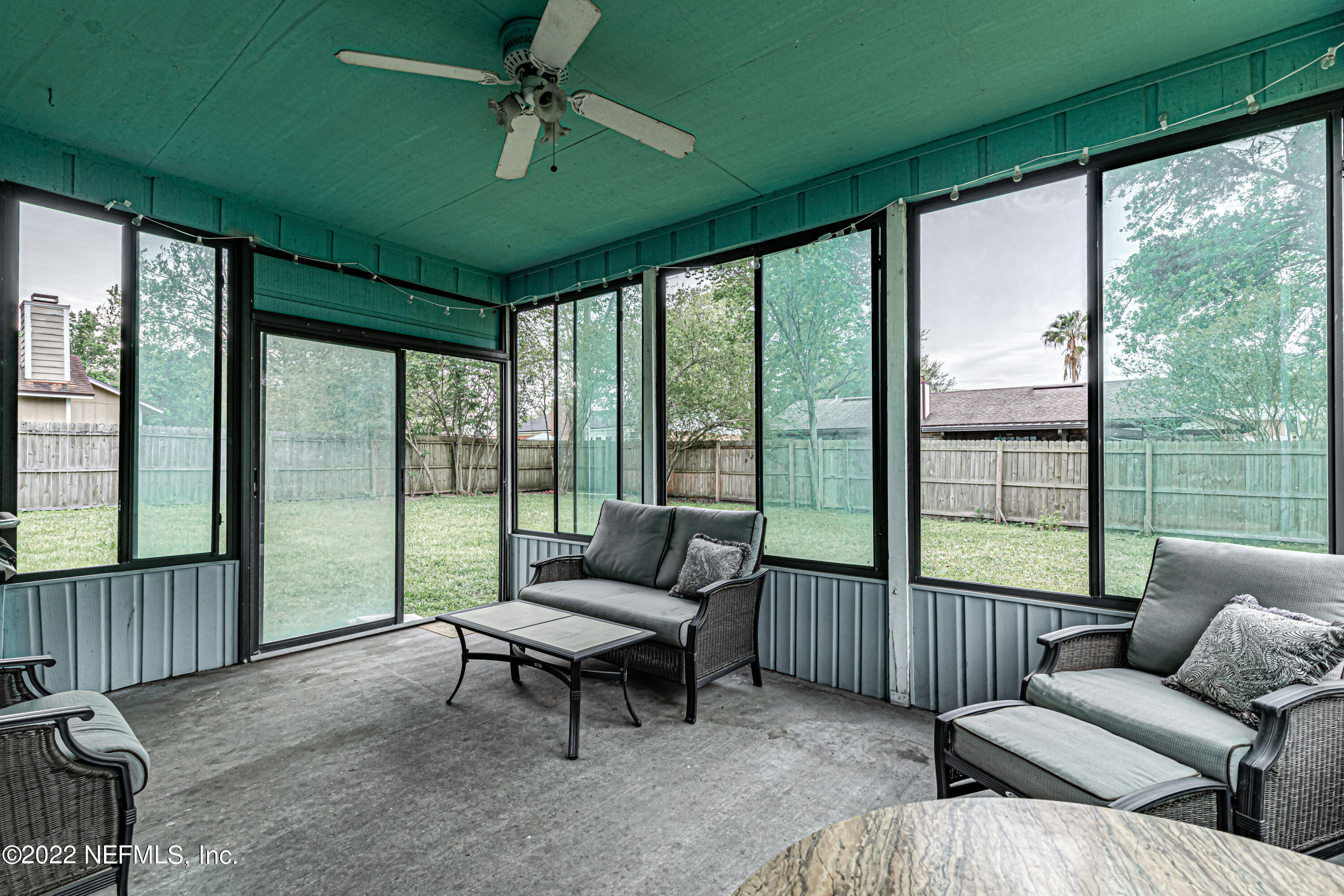554 George Taylor Street Orange Park, FL 32073 - Photo 35 of 40 a living room with furniture and a floor to ceiling window