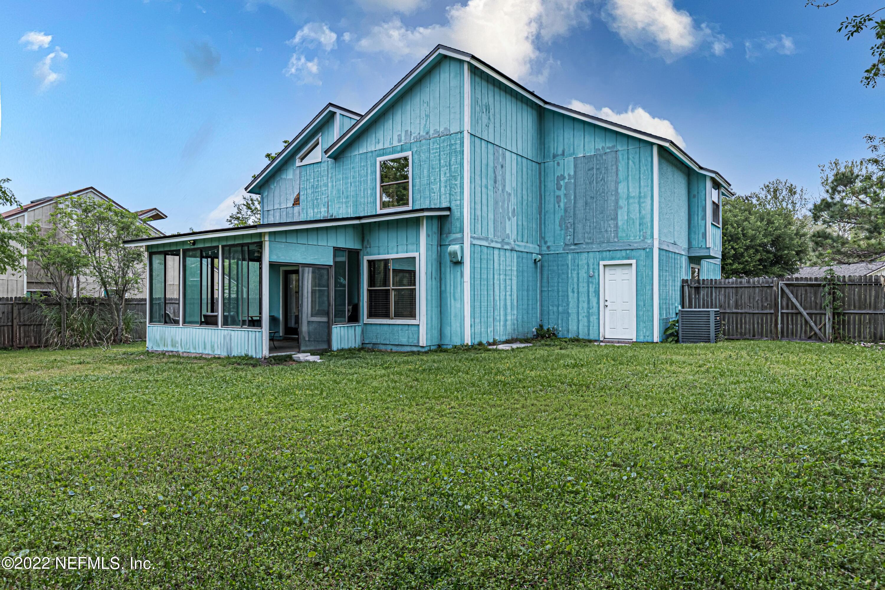 554 George Taylor Street Orange Park, FL 32073 - Photo 38 of 40 a front view of house with a garden