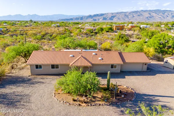 an aerial view of a house with a yard and lake view