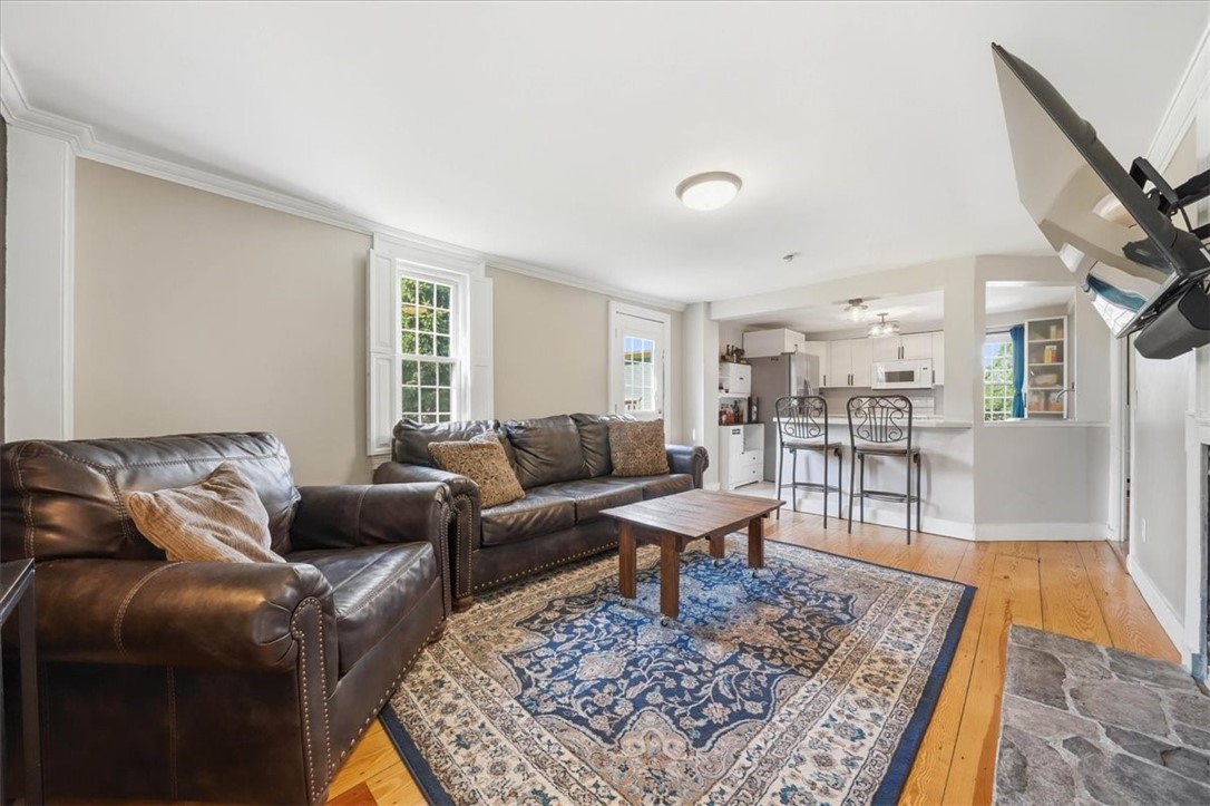 32 Equestrian Way Cranston, RI 02921 - Photo 14 of 50 Natural light, wide-plank flooring and open breakfast-bar seating make the living room feel bright, connected and welcoming.