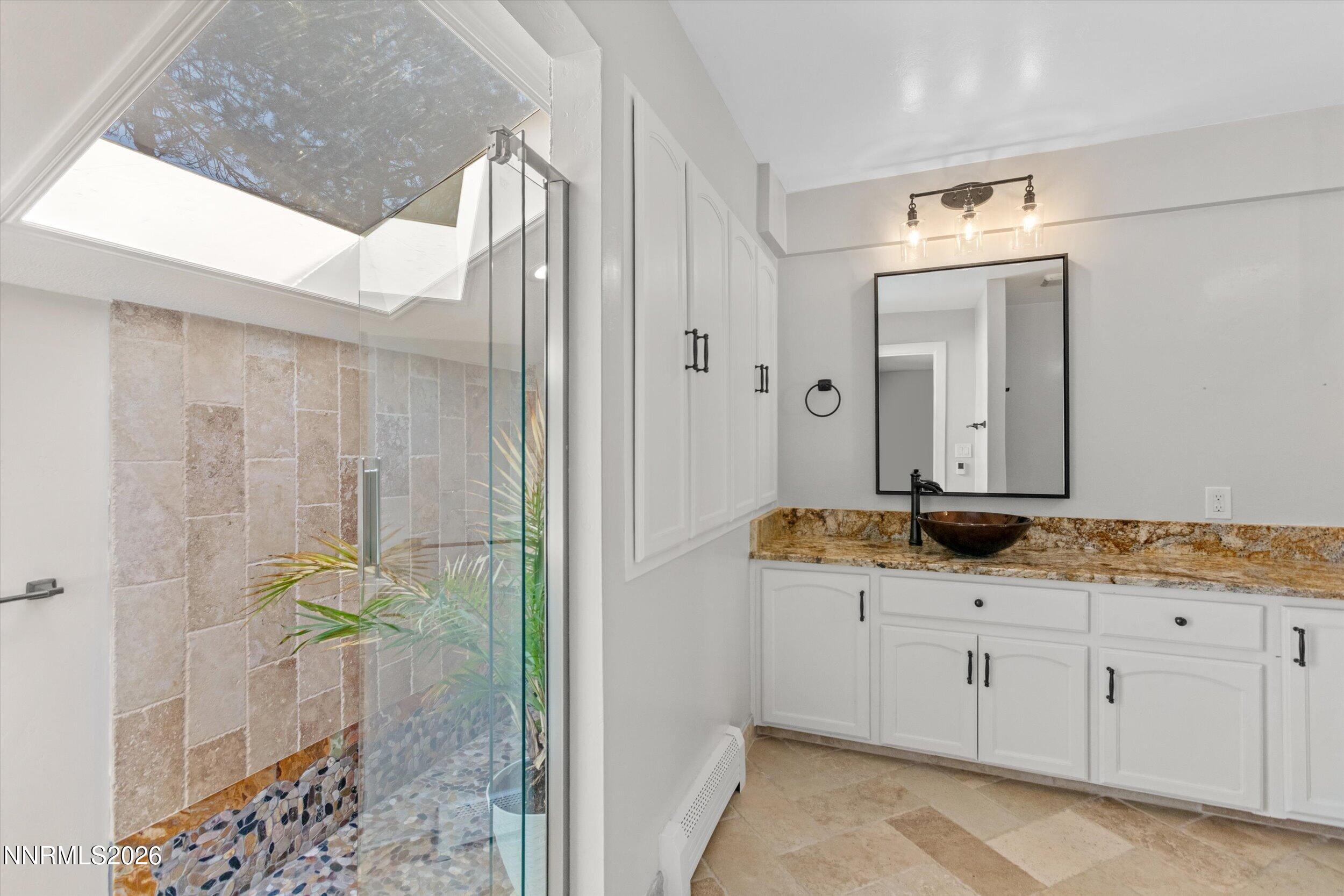 2725 West Lake Ridge Shores Reno, NV 89519 - Photo 24 of 49 a bathroom with a granite countertop sink a mirror and a shower