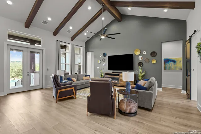 a view of a hallway with wooden floor and a bathroom