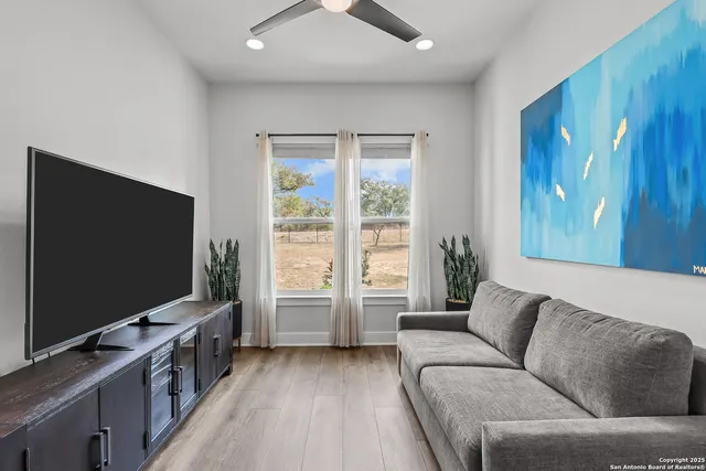 a spacious bathroom with a granite countertop sink a toilet a mirror and shower