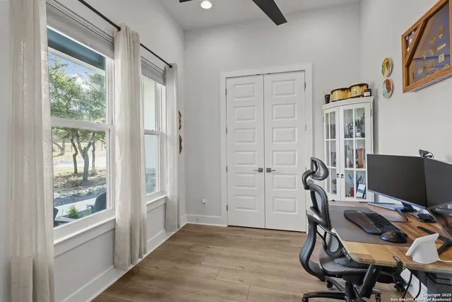 a spacious bathroom with a tub sink and mirror