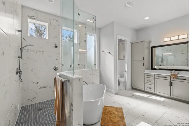 an aerial view of residential houses with outdoor space and trees