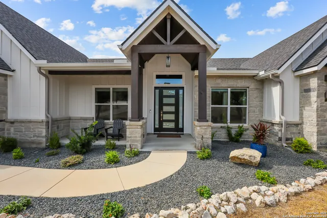 a large kitchen with stainless steel appliances granite countertop a lot of counter space and wooden floors
