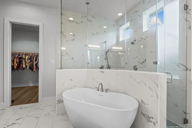 a kitchen with stainless steel appliances granite countertop a sink refrigerator and cabinets