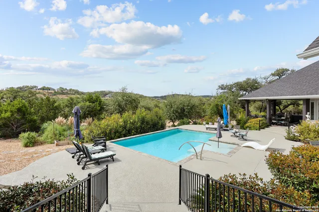 a bathroom with a granite countertop sink mirror and a bath tub