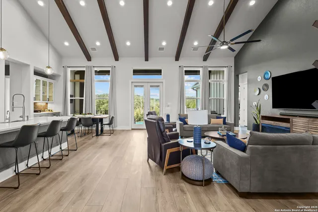 a kitchen with stainless steel appliances granite countertop a sink a stove and wooden cabinets