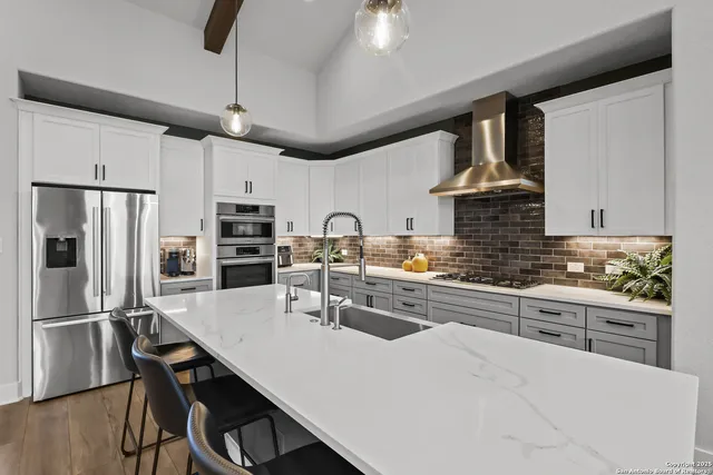 a living room with furniture a ceiling fan and a flat screen tv