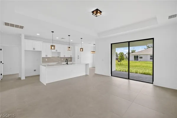 a view of a kitchen with refrigerator and an ocean view