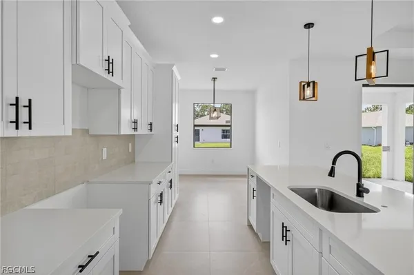 a kitchen with kitchen island a sink stainless steel appliances and cabinets