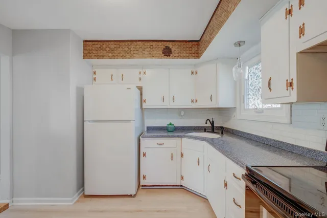 a kitchen with a white cabinets and white appliances