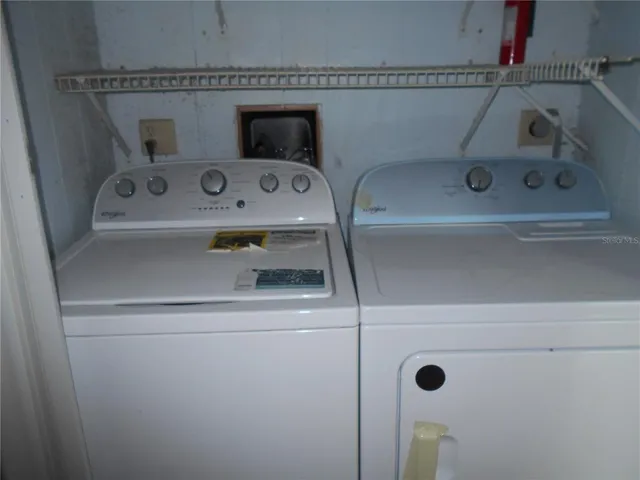 a kitchen with a refrigerator and a stove