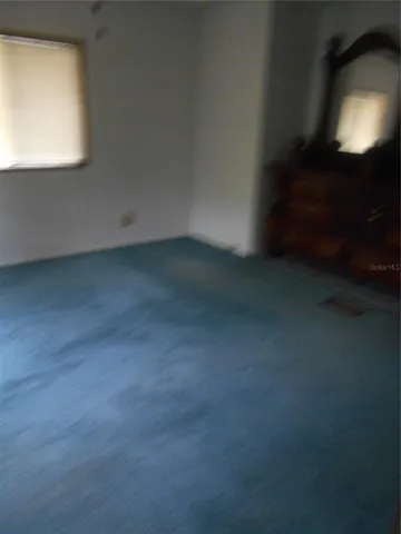 a kitchen with stainless steel appliances kitchen island granite countertop a sink dishwasher and a refrigerator with wooden floor