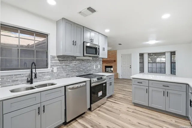a kitchen with a sink stove and cabinets