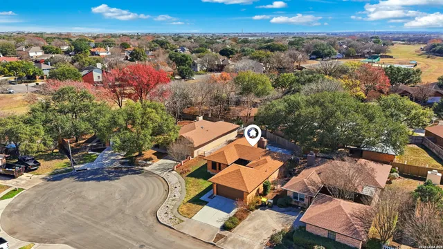 an aerial view of residential houses with outdoor space